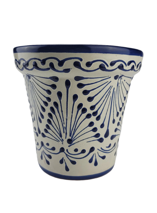 Ceramic cup with blue floral pattern on a white background