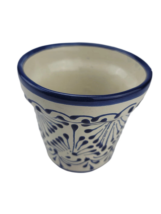Ceramic vase with blue and white pattern on a light gray background
