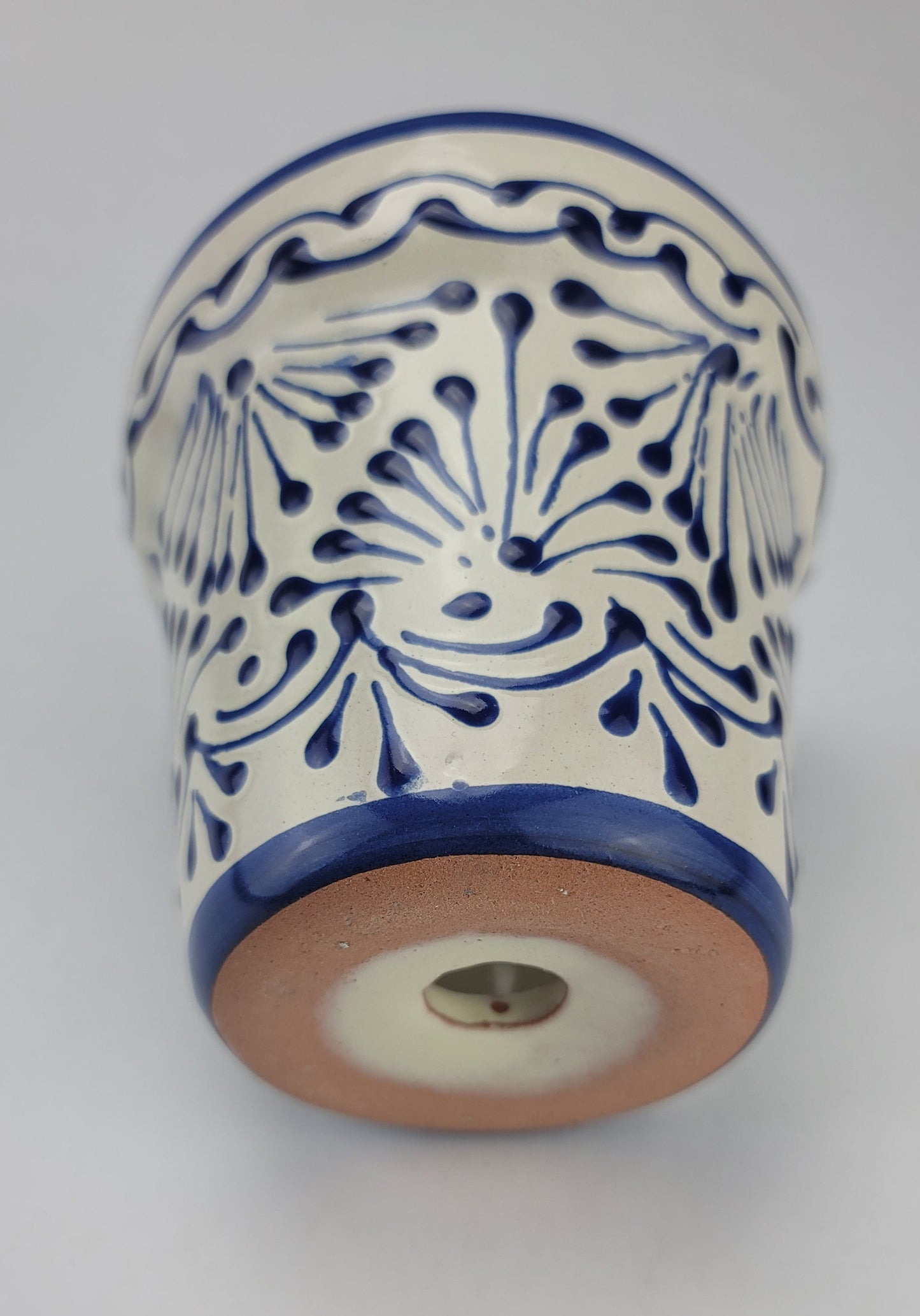 Ceramic vase with blue and white pattern on a light gray background