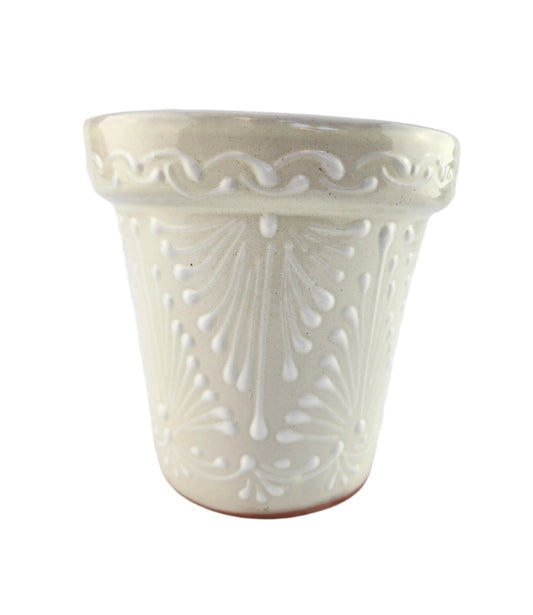 Decorative white ceramic item with intricate patterns on a light gray background