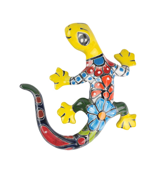 Colorful ceramic lizard with floral patterns on a white background