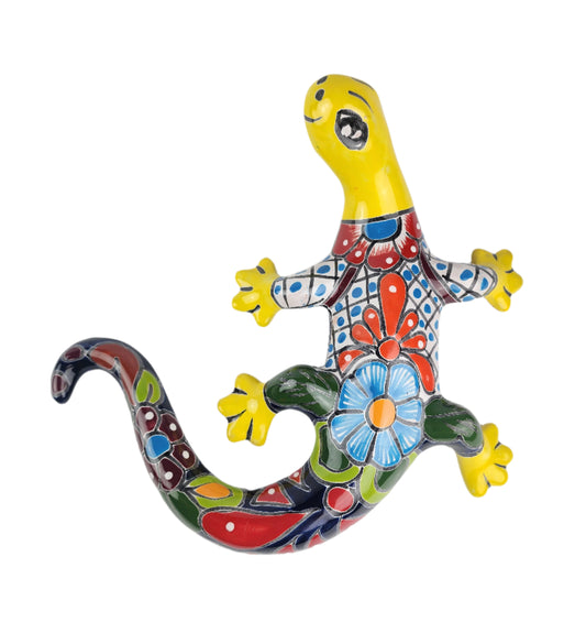 Colorful ceramic lizard with floral design on a white background