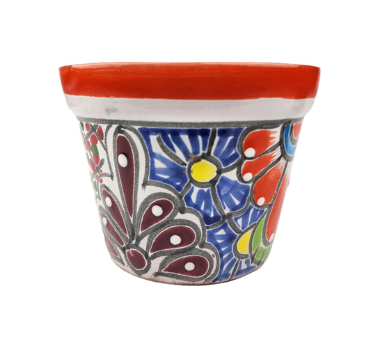 Decorative ceramic planter with floral patterns on a white background