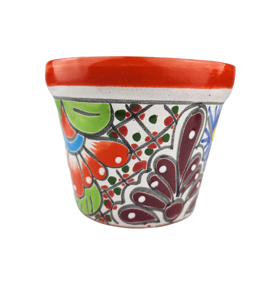 Decorative ceramic pot with colorful patterns on a white background