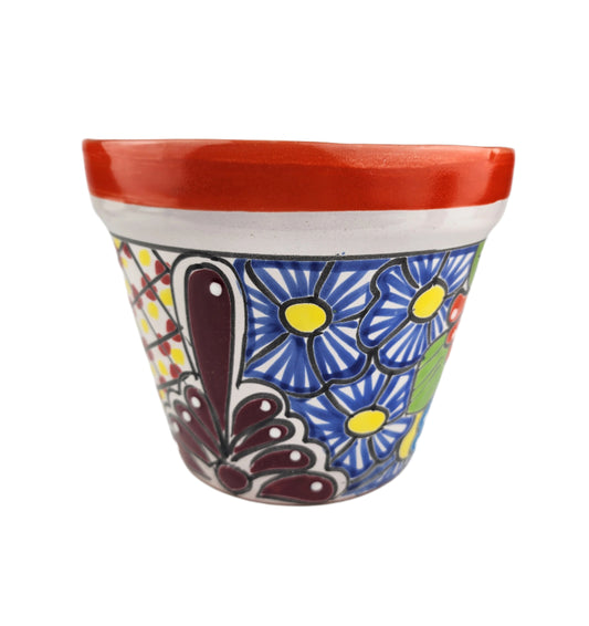 Decorative ceramic planter with floral design on a white background