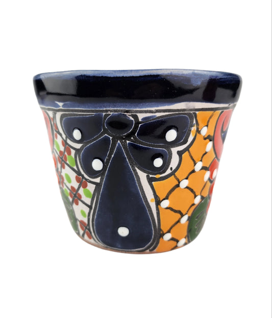 Ceramic planter with colorful design on a white background