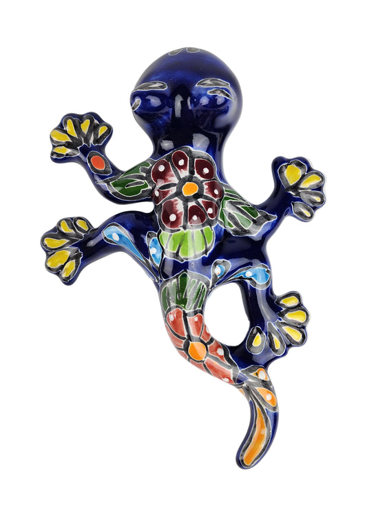 Decorative ceramic lizard with floral design on a white background