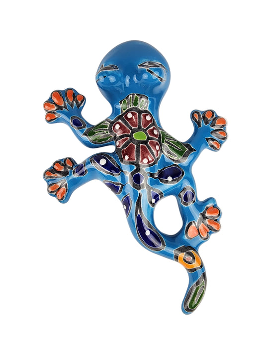 Decorative blue lizard figurine with colorful patterns on a white background