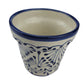Ceramic vase with blue and white pattern on a light gray background