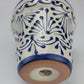 Ceramic vase with blue and white pattern on a light gray background