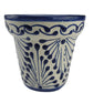 Ceramic wall hanging with blue floral pattern on a white background