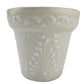 White ceramic planter with decorative patterns on a white background