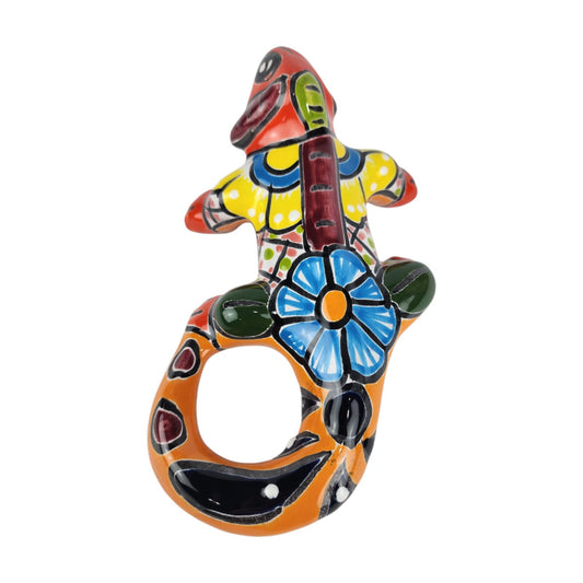 Red orange Talavera-style ceramic iguana with blue, green, and multicolor patterns displayed on a white background.