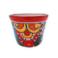 Colorful small ceramic planter with floral design on a white background