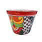 Colorful ceramic planter with floral patterns on a white background