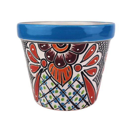 A small ceramic planter pot with a glossy blue rim and a colorful hand-painted traditional Mexican Talavera style floral pattern on a white background.