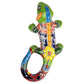 Colorful ceramic lizard wall art on a white background