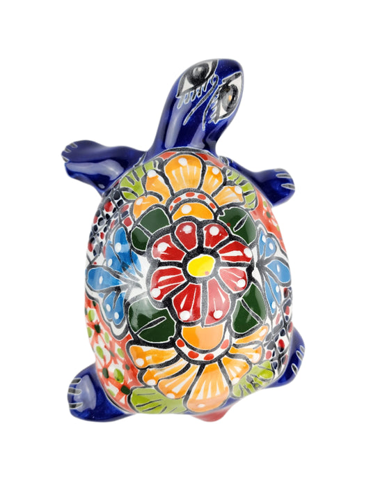 Colorful turtle figurine with floral design on a white background