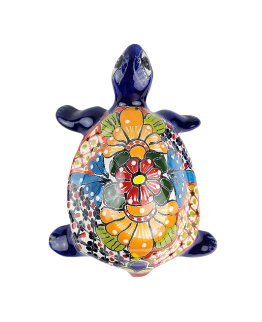 Colorful turtle figurine with floral patterns on a white background