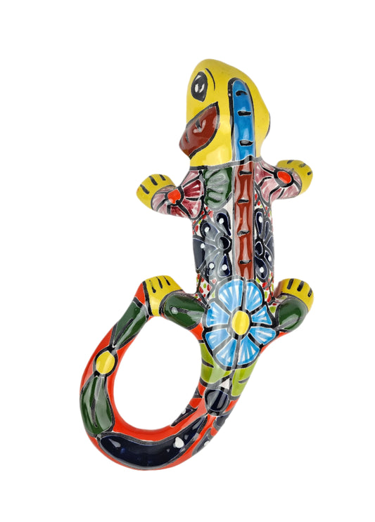Colorful ceramic lizard sculpture on a white background