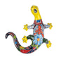 Colorful ceramic lizard with floral design on a white background