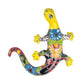 Colorful ceramic lizard wall art on a white background
