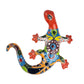 Colorful ceramic lizard wall art on a white background