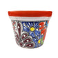 Decorative ceramic planter with floral patterns on a white background