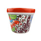 Decorative ceramic pot with colorful patterns on a white background