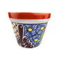Decorative ceramic planter with floral design on a white background