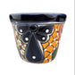 Ceramic planter with colorful design on a white background