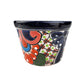 Decorative ceramic planter with colorful patterns on a white background