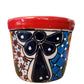 Decorative ceramic planter with floral design on a white background