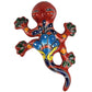 Colorful ceramic lizard wall hanging on a white background