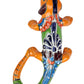 Colorful ceramic lizard wall art on a white background