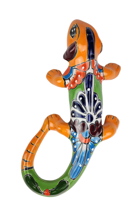 Colorful ceramic lizard wall art on a white background
