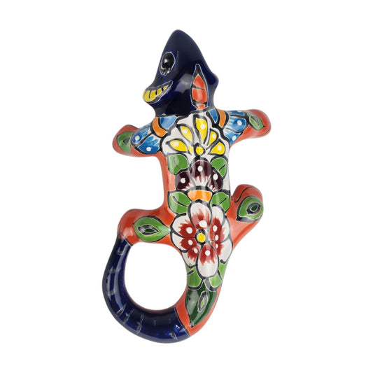Orange Talavera-style ceramic iguana with colorful floral and geometric patterns displayed on a white background.