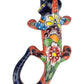Decorative ceramic lizard with floral patterns on a white background