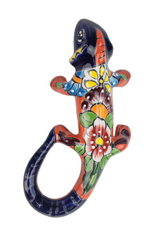 Decorative ceramic lizard with floral patterns on a white background