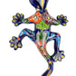 Colorful ceramic lizard wall art on a white background