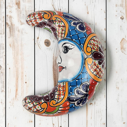 Blue Talavera-style ceramic moon wall décor with colorful floral and geometric patterns on white background