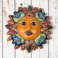 Talavera-style ceramic sun wall décor with colorful floral patterns on rustic white wood background