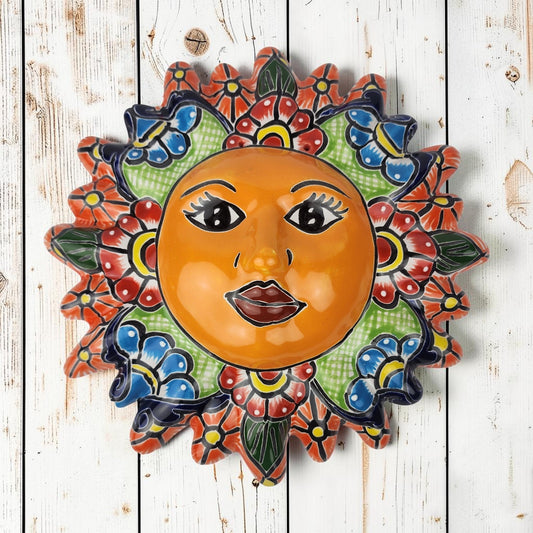 Talavera-style ceramic sun wall décor with colorful floral patterns on rustic white wood background