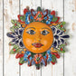 Red Talavera-style ceramic sun wall décor with colorful floral patterns displayed on rustic white wood background