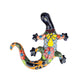 Colorful ceramic lizard wall art on a white background