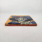 Golden yellow Catrina Portrait ceramic tile shown from front edge highlighting ceramic thickness and natural terracotta edge