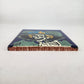 Blue Catrina Portrait ceramic tile shown from front edge highlighting ceramic thickness and glazed surface