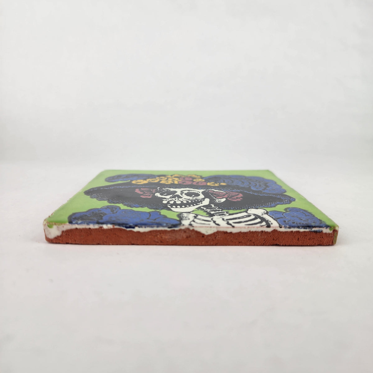 Lime green Catrina Portrait ceramic tile shown from front edge highlighting ceramic thickness and natural terracotta edge