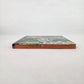 Navy blue Catrina Portrait ceramic tile shown from front edge highlighting ceramic thickness and natural terracotta edge