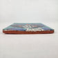 Teal Catrina Portrait ceramic tile shown from front edge highlighting ceramic thickness and natural terracotta edge